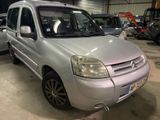 a silver van parked in a garage with other cars