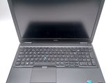a laptop that is open on a white surface