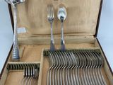 a wooden box with silverware in it on a table