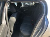 the back seat of a car with the door open and the driver ' s seat down