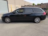 a picture of a black minivan parked in a parking lot