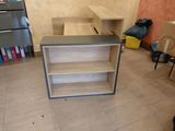 a desk with a book shelf in the middle of the room
