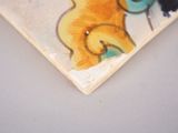 a picture of a skateboard with a picture of a cat and a bird on it