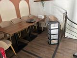 a table and chairs in a room with a spiral staircase