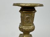 a gold vase that is sitting on a table