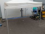 a white tent that is set up in front of a building