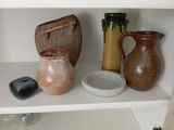 trois vases posés sur une étagère dans un coin de la pièce