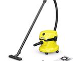 un gros plan d'un aspirateur jaune muni d'un tuyau noir