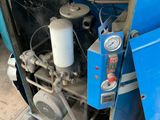 a blue machine that is sitting on the ground