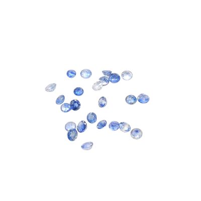a bunch of blue sapphires on a white surface