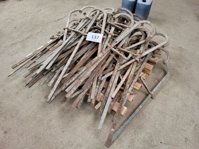 a pile of old tools on the ground next to a blue fire hydrant