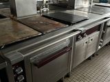 a large kitchen with many stainless steel appliances in it