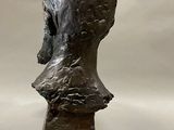sculpture of a woman ' s head on a pedestal on a white background