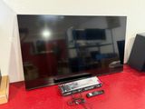 a flat screen tv sitting on a red table