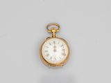 a gold pocket watch with roman numerals and roman numerals