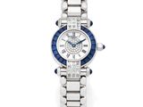 une montre pour femme en diamants et saphirs, signée Cartier