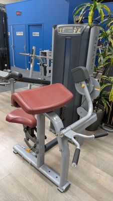 an image of a gym room with a row of exercise equipment