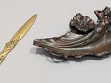 bronze figurine of a woman with a fan and a gold spoon