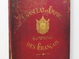an old book sitting on a table with a red cover