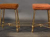 pair of antique brass stools with red upholstered cushions