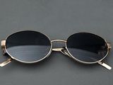 sunglasses on a gray surface with a black background