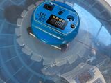 a plastic container with a blue electronic device inside of it