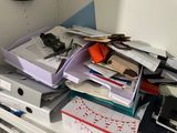 a cluttered desk with a lot of papers on it