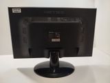a black computer monitor on a stand on a table