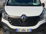 the front view of a white van parked in a parking lot