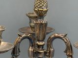 a silver candelier with pineapples on it
