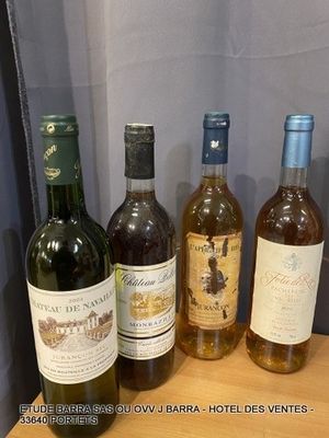several bottles of wine are lined up on a wooden shelf