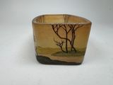 a small bowl that has a picture of a tree on it