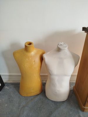 three mannequins sitting next to each other on the floor