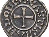 a close up of a coin with a cross on it