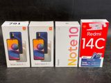 three redmi 4c smartphones are sitting on a table next to each other