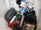 a bag full of items that are sitting on a bed