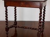 an old wooden table with a drawer on top of it