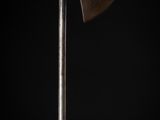 an old axe with a wooden handle on a black background