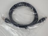 a close up of a black cable wrapped in plastic on a white surface
