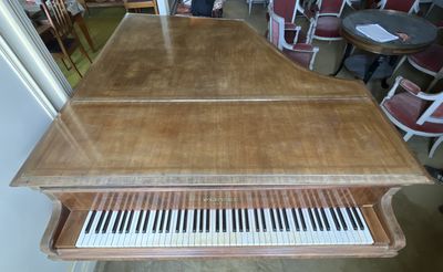 a piano that is sitting in the middle of a room