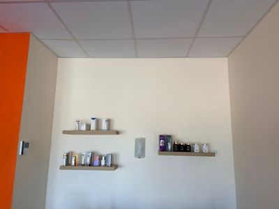 two shelves on the wall above a bed in a room