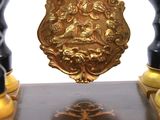 an image of a clock with a gold plate on it