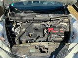 a car with its hood open and the engine in the trunk