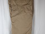 khaki pants hanging on a hanger on a white background