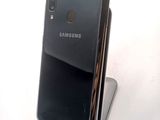 a close up of the back of a black samsung phone