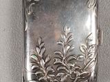 a small silver box with a design on it