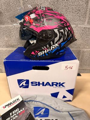 a box with a helmet on top of it next to a pair of gloves