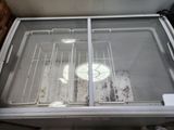 a refrigerator with a glass door that has a lot of food inside of it