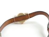 leather bracelet with a gold plated clasp on a white background