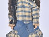 a doll that is wearing a hat and dress